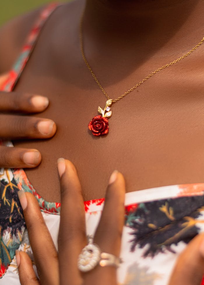 Close-up of a rose-themed gold necklace adorning an African woman in Ado Ekiti, Nigeria.